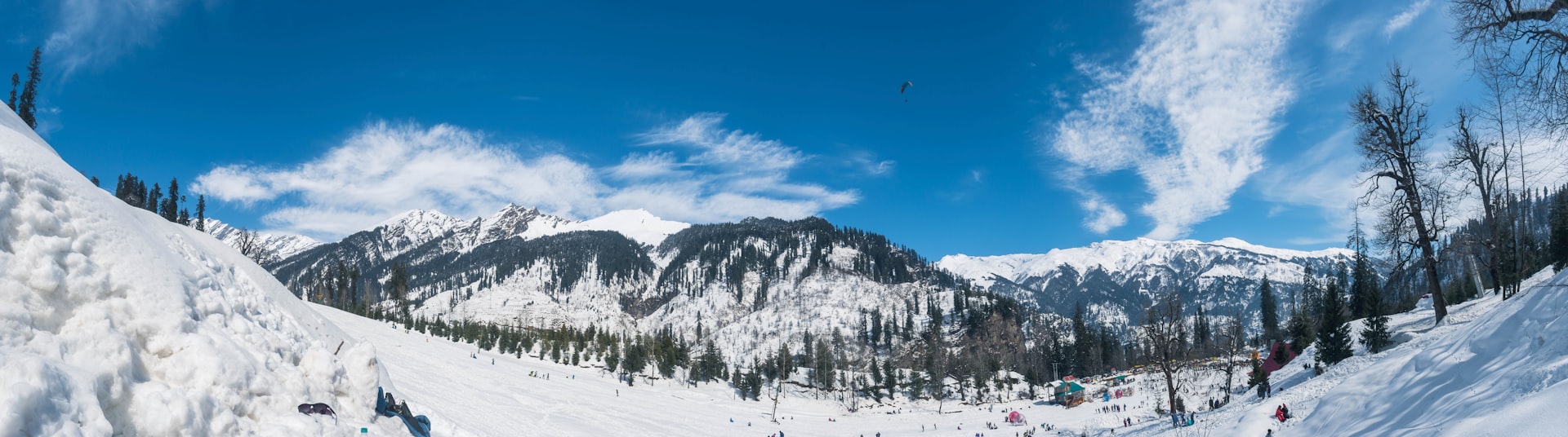 a group of people riding skis down a snow covered slope